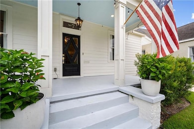 Doorway to property featuring covered porch