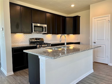 Kitchen featuring appliances with stainless steel