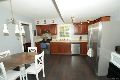 Spacious kitchen with cherry cabinets and stainles