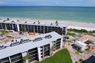 Aerial view featuring a view of the beach and a wa