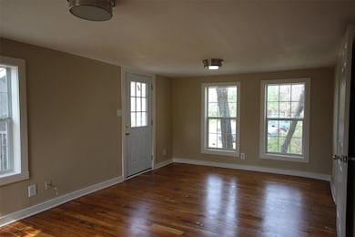 Entrance foyer with wood-type flooring and basebo