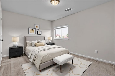 Bedroom featuring light carpet and baseboards