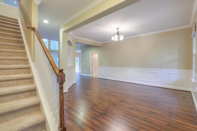 Dramatic wall of windows to the woods behind. There is some green space behind this lot.