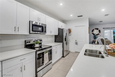 Kitchen with light tile patterned floors, stainles