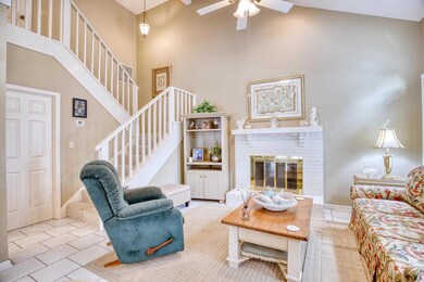Living room featuring a fireplace, high vaulted ce