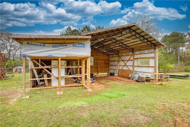 View of outdoor structure with a detached carport and an outdoor structure