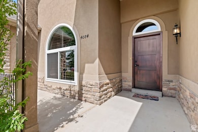 View of exterior entry featuring stone siding and stucco siding