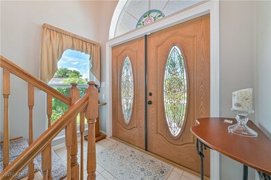 Foyer entrance with light tile patterned flooring