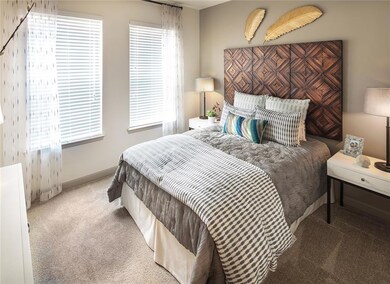 Carpeted bedroom with multiple windows