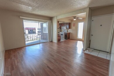 Unfurnished living room featuring a textured ceiling, light wood-style floors, and plenty of natural light