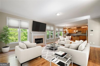 Family Room has Hardwood Flooring and Marble Firep