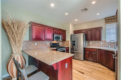 Kitchen featuring breakfast bar, stainless steel a