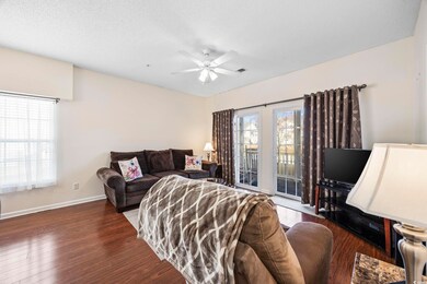 Living room with a textured ceiling, dark hardwood