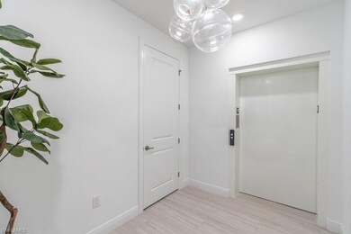 Doorway to outside featuring an inviting chandelie