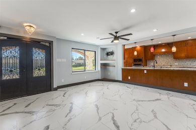Foyer with light marble finish flooring, recessed lighting, french doors, and a ceiling fan
