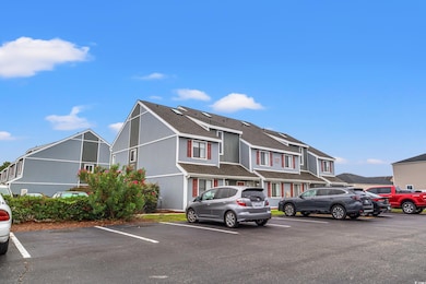 View of front of property featuring a shingled roof, a residential view, uncovered parking, and stucco siding