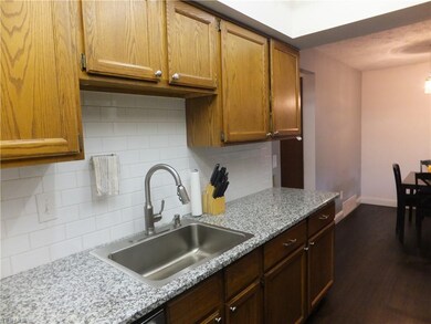 Newer sink, faucet, subway tile backsplash.
