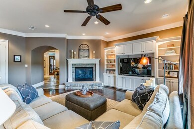 ...Custom built-ins and corner gas log fireplace....