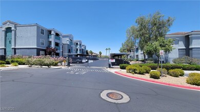 View of asphalt street with curbs, a gate, traffic