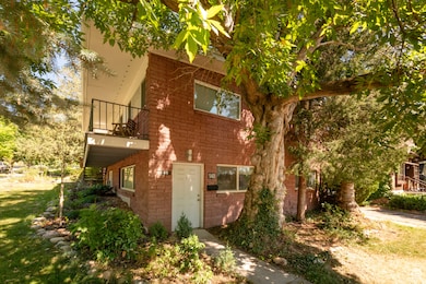 View of home's exterior featuring a balcony and brick siding