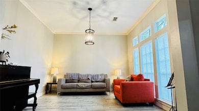 Bright living room with high ceilings, featuring l