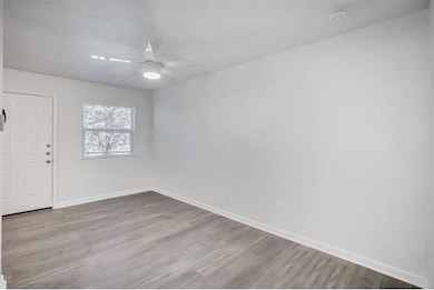 Spare room featuring ceiling fan and light hardwoo
