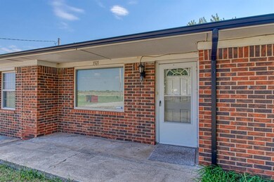 Property entrance featuring brick siding