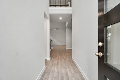 The grand entrance beckons with high ceilings, ado
