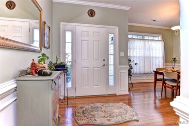 Foyer with light hardwood / wood-style floors and
