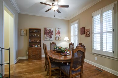 Formal (or informal) Dining Room showcases the sand and finished hardwood floors you will find downstairs and Plantation Shutters Throughout! 