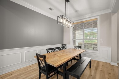 Dining area with ornamental molding, a wainscoted