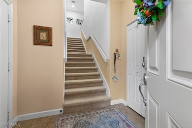 Entrance foyer with stairs and baseboards