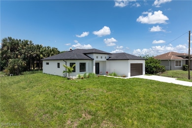Prairie-style home with concrete driveway, a garag