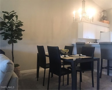 Carpeted dining room featuring baseboards and a no