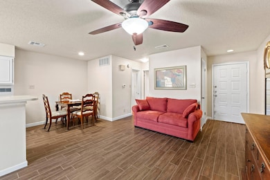 Living room with visible vents and wood tiled flo