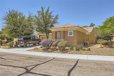 View of front of home with an attached garage, stu