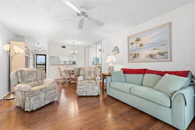 View of living/dining room toward kitchen and entryway. This home comes fully furnished!  You can just move right in!