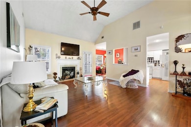 Living room with high vaulted ceiling, a ceiling f