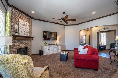 Living room featuring crown molding and ceiling fa