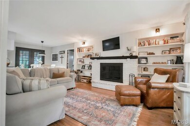 Living room with wood finished floors and a fireplace