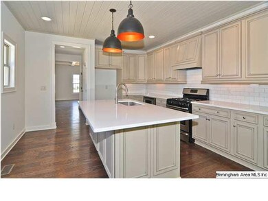 Kitchen with large island! This home how has upgraded appliance package including range and fridge!