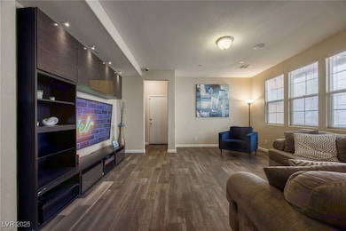 Living room with dark wood finished floors and bas