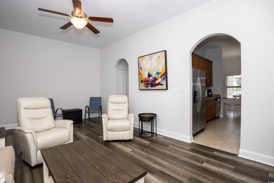 Living area featuring baseboards, wood finished fl