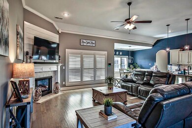 Living room with ceiling fan, dark wood-type floor