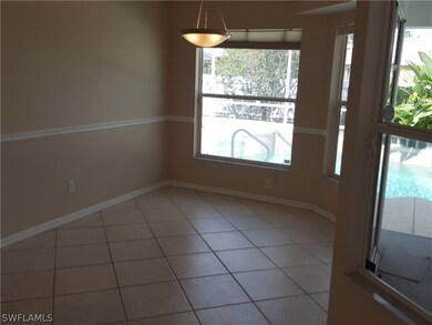 Breakfast nook off kitchen with slider to lanai and pool area