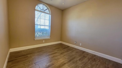 Empty room featuring dark wood finished floors an