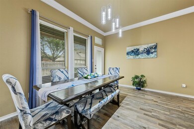 Dining area featuring crown molding, hardwood / wo