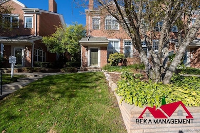 View of front of home featuring a front yard, brick siding, and a chimney