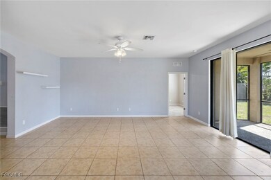 Spare room with ceiling fan and light tile pattern