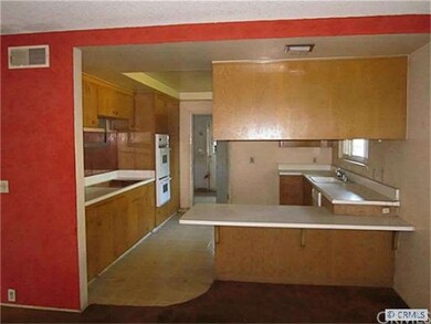 Light, open kitchen opens to the formal dining roo